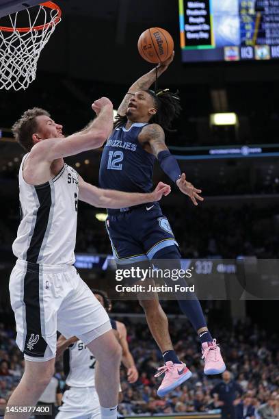 Ja Morant of the Memphis Grizzlies goes to the basket against Jakob Poeltl of the San Antonio Spurs during the second half at FedExForum on January...