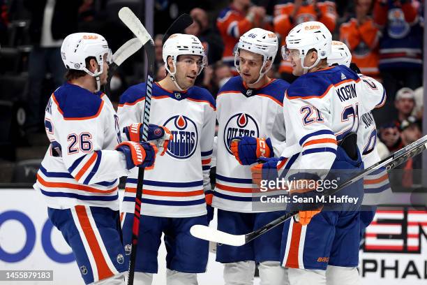Mattias Janmark, Evan Bouchard, Klim Kostin and Philip Broberg of the Edmonton Oilers congratulate Ryan Nugent-Hopkins of the Edmonton Oilers after...