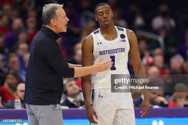 Head coach Chris Collins of the Northwestern Wildcats talks with Chase Audige against the Rutgers Scarlet Knights during the first half at Welsh-Ryan...