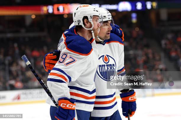 Cody Ceci congratulates Connor McDavid of the Edmonton Oilers after his goal during the first period of a game against the Anaheim Ducks at Honda...