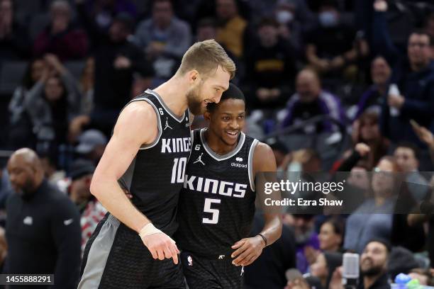 Domantas Sabonis and De'Aaron Fox of the Sacramento Kings react after Trey Lyles made a three-point basket against the Houston Rockets in the second...