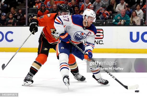 Connor McDavid of the Edmonton Oilers controls the puck past the defense of Cam Fowler of the Anaheim Ducks during the third period of a game at...