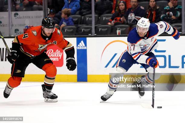 Connor McDavid of the Edmonton Oilers controls the puck past the defense of Cam Fowler of the Anaheim Ducks during the third period of a game at...