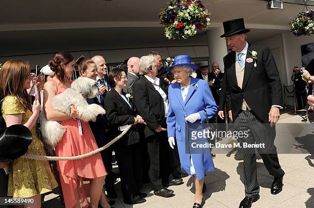Britain's Got Talent winners Ashleigh Butler and dog Pudsey watch as Queen Elizabeth II walks with Anthony Cane, Chairman of Epsom Downs Race Course,...