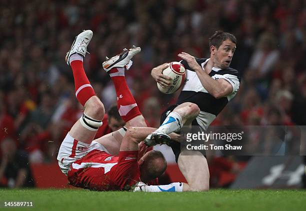 Shane Williams of the Barbarians is tackled during the international match between Wales and The Barbarians at Millennium Stadium on June 2, 2012 in...