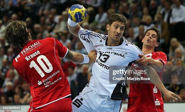 Marcus Ahlm of Kiel challens Adrian Pfahl of Gummersbach during the Toyota Handball Bundesliga match between THW Kiel and VfL Gummersbach at...