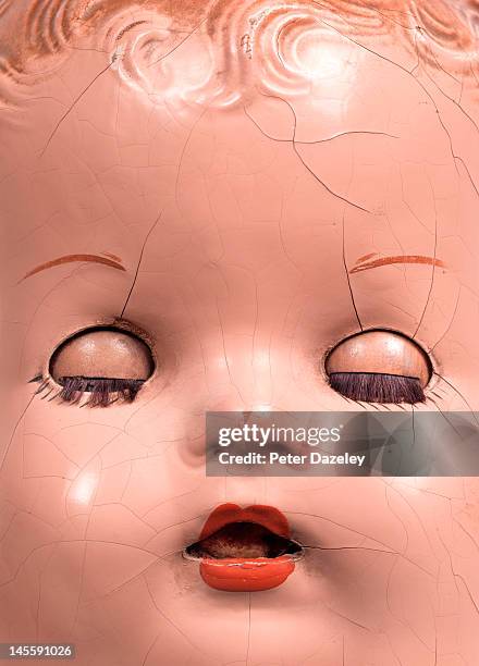 close up of damaged and cracked dolls face - broken toy stock pictures, royalty-free photos & images