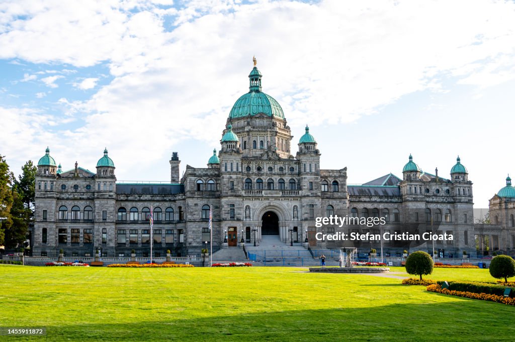 Historic parliament building in Victoria with colorful flowers, British Columbia, Canada