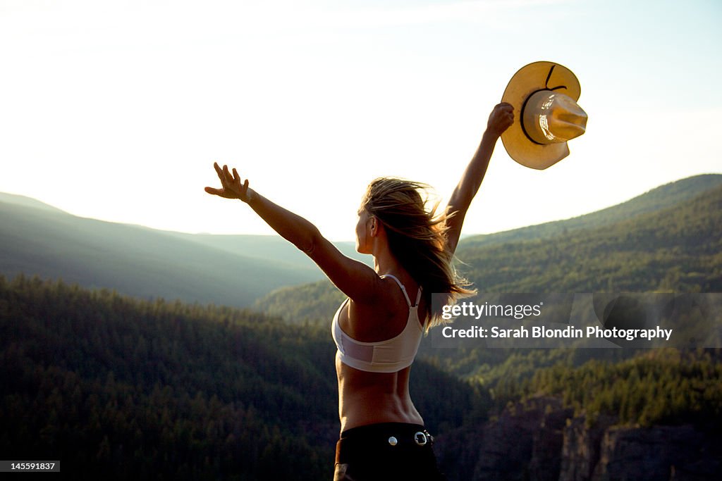 Cowgirl on top of mountain