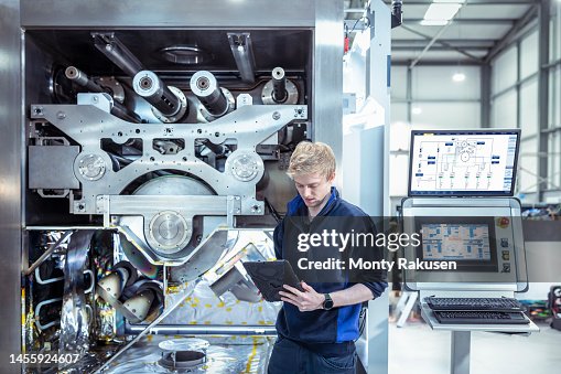 Designer engineer with vacuum coating machine for automotive battery use Designer engineer with vacuum coating machine for automotive battery use