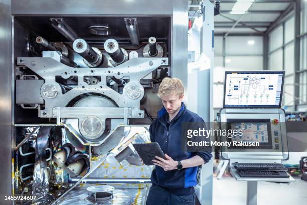 designer engineer with vacuum coating machine for automotive battery use - evolution stock pictures, royalty-free photos & images