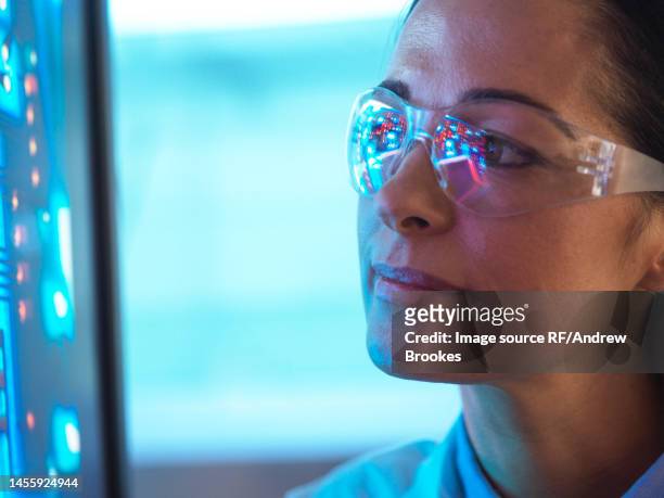 scientist in glasses looking at screen - woman spectacles stock pictures, royalty-free photos & images