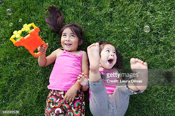 Toddler girls playing with bubbles