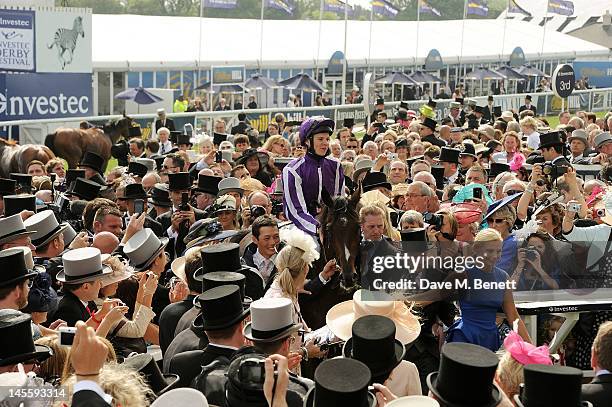 Jockey Joseph O'Brien rides winner of the Investec Derby 'Camelot' into the winners circle during Investec Derby Day at the Investec Derby Festival,...