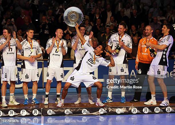 Daniel Narcisse of Kiel celebrate lifts the trophy after winning the german handball championship after the Toyota Handball Bundesliga match between...