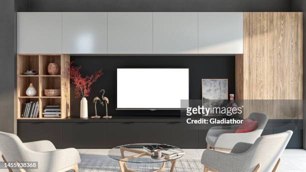 modern living room with a tv on a cabinet - salon tv stockfoto's en -beelden