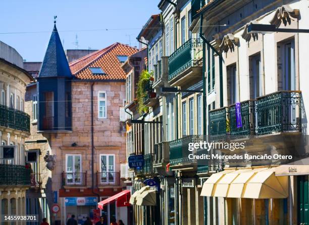street view,  incidental people, multicolored houses, awnings, vila real, portugal. - vila real district portugal stockfoto's en -beelden