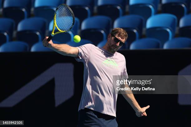 Dirk Nowitzki plays tennis against Alexander Zverev during a practice session ahead of the 2023 Australian Open at Melbourne Park on January 12, 2023...