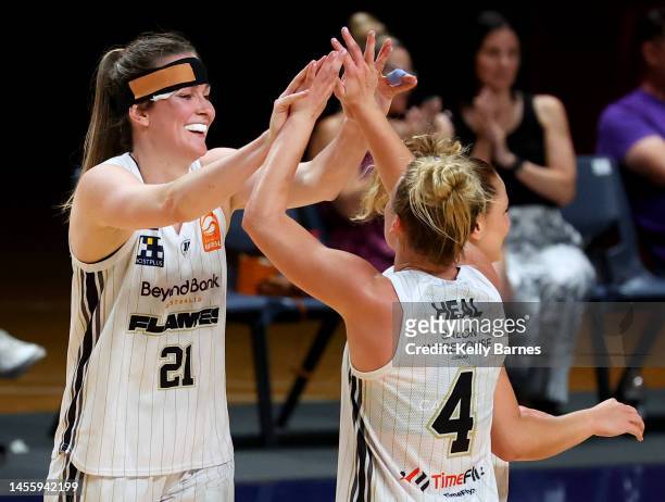 Keely Froling and Shyla Heal of the Flames High five after win during the round 10 WNBL match between Adelaide Lightning and Sydney Flames at...