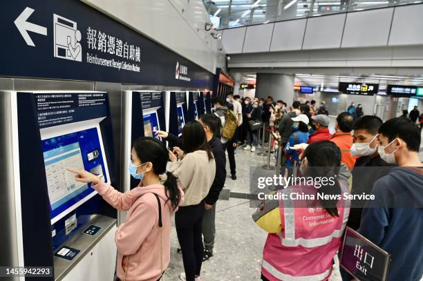 Citizens buy train tickets from ticket vending machines at Hong Kong West Kowloon Railway Station on January 12, 2023 in Hong Kong, China. Train...