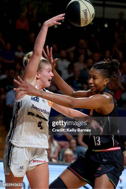 Shyla Heal of the Flames gets a pass past Jacinta Monroe of the Lightning during the round 10 WNBL match between Adelaide Lightning and Sydney Flames...