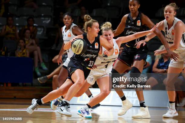 Lauren Mansfield of the Lightning guarded by Shyla Heal of the Flames during the round 10 WNBL match between Adelaide Lightning and Sydney Flames at...