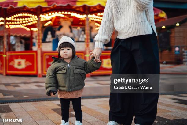 cheerful young asian mother and toddler at funfair - japanese ethnicity stock pictures, royalty-free photos & images