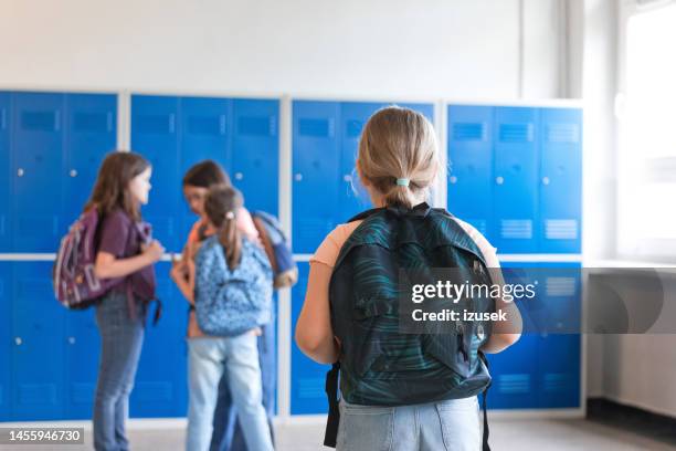 school girls standing in the school corridor - kids school lockers stock pictures, royalty-free photos & images