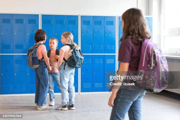 school girls standing in the school corridor - sad girl standing stock pictures, royalty-free photos & images