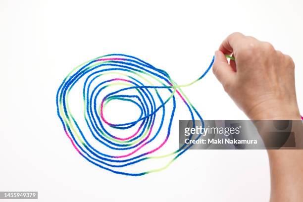 hands manipulating colorful threads. - 調布 stockfoto's en -beelden