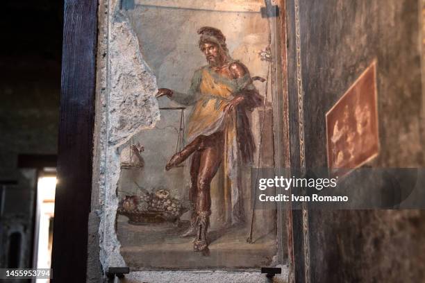 Fresco depicting God Priapus in the House of the Vettii is seen in the Archaeological Park of Pompeii on January 11, 2023 in Pompei, Italy. The Casa...