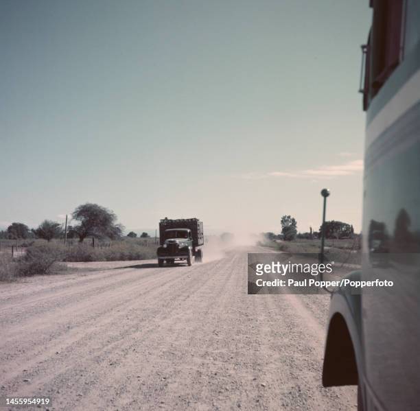View from a bus of a truck driving along a modern highway near the city of Salta in the northern province of Salta in Argentina, South America circa...
