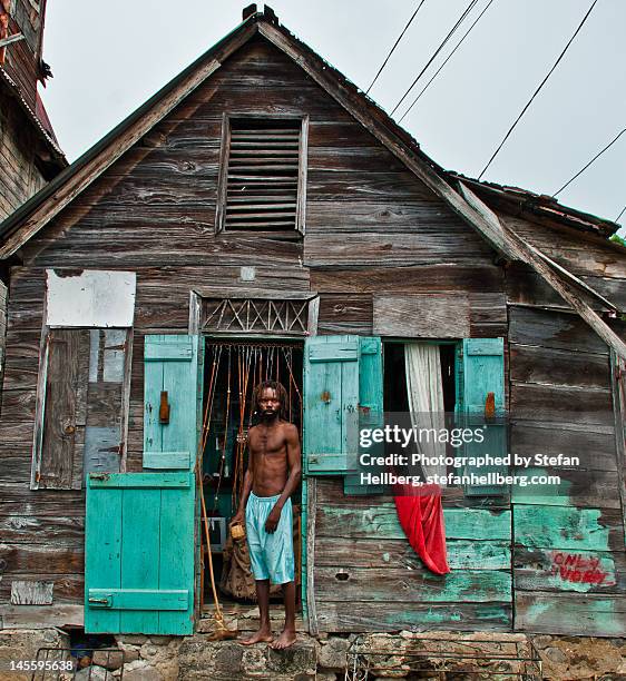 dark man at his old wooden house - metallic shorts stock pictures, royalty-free photos & images