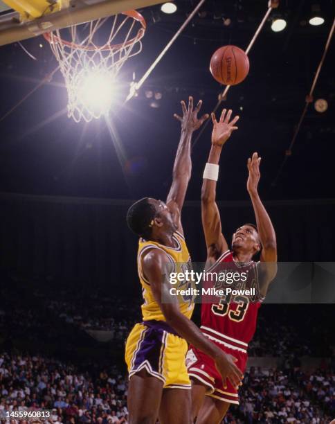 Scottie Pippen, Small Forward for the Chicago Bulls attempts a one handed lay up shot to the basket over James Worthy, Small Forward and Power...