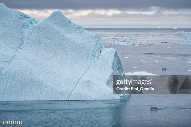 boat sailing among the icebergs at ilulissat icefjord, greenland - disko bay stock pictures, royalty-free photos & images