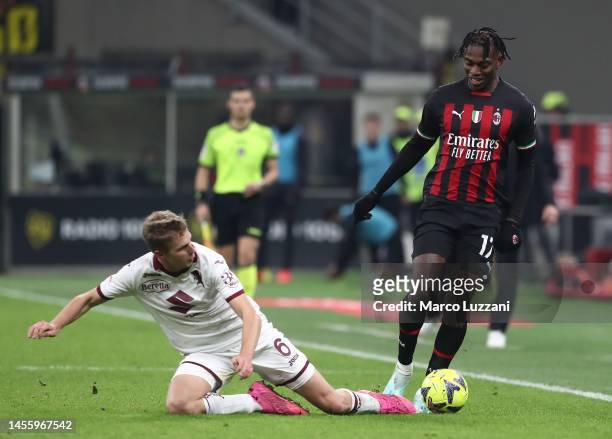 Rafael Leao of AC Milan is challenged by David Zima of Torino FC during the Coppa Italia match between AC Milan and Torino FC at Stadio Giuseppe...
