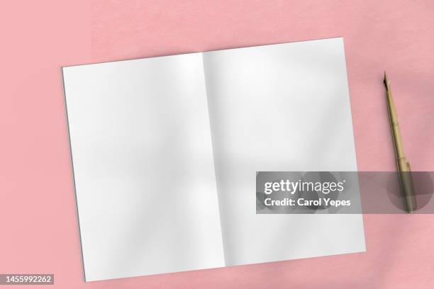magazine template in pink surface casting shadows - mockup book stock-fotos und bilder