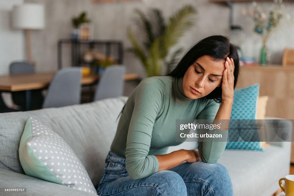 Young Woman Having A Headache At Home