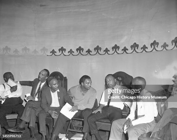 View of, from second left, Civil Rights activists Albert Raby , James Bevel , Jesse Jackson, and Dr Martin Luther King Jr , with others, as they sit...