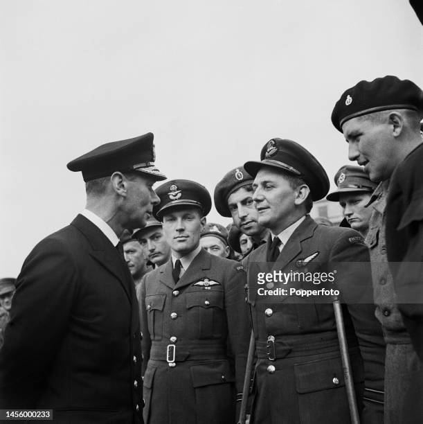 King George VI meets with British and Commonwealth servicemen, all recently repatriated prisoners of war, at a garden party in the grounds of...