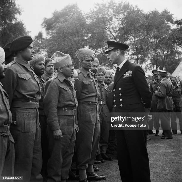 King George VI meets with Commonwealth servicemen from the Indian Army, all recently repatriated prisoners of war, at a garden party in the grounds...