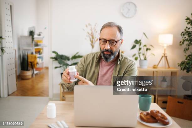 casually clothed man on online consultation with doctor - virtual visit stock pictures, royalty-free photos & images