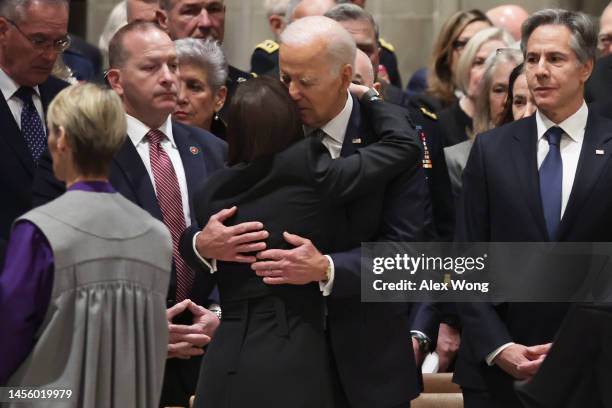 President Joe Biden hugs widow Stephanie Carter as Secretary of State Antony Blinken looks on during a memorial service for former Secretary of...