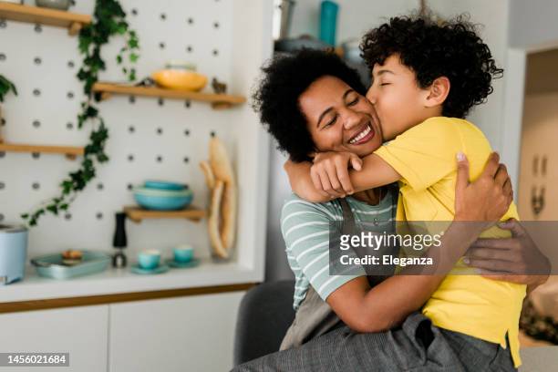 smiling family in a hug, mother and young son.,  mother hugging her male child - healthy family stock pictures, royalty-free photos & images