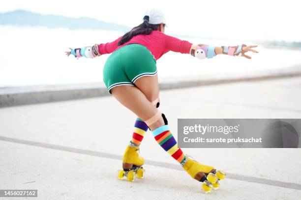 young woman showing skill  roller skating . - shorts down stock pictures, royalty-free photos & images