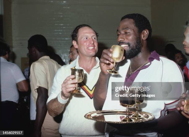 West Indies batsman Viv Richards and England batsman Geoff Boycott chat as they take a drink out of some golden goblets in the dressing room after...