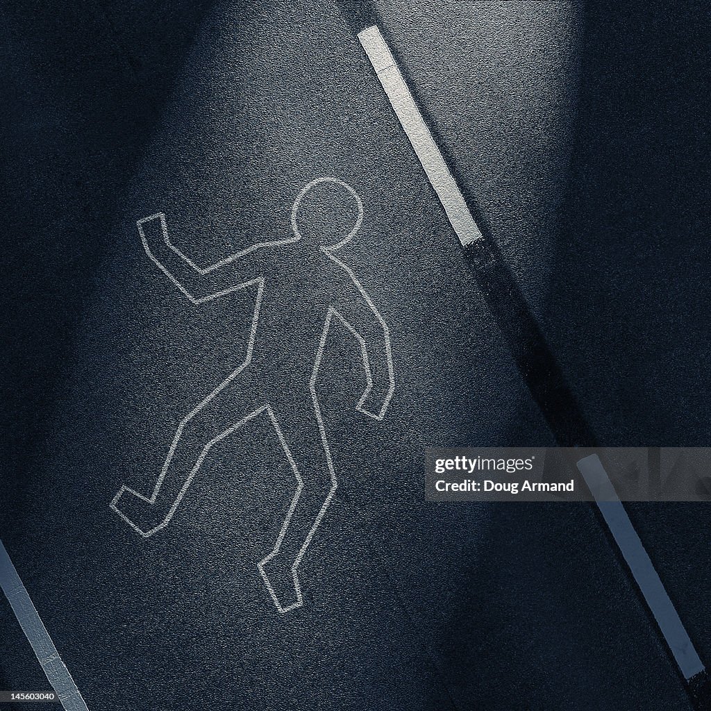 Chalk outline of a body on a road