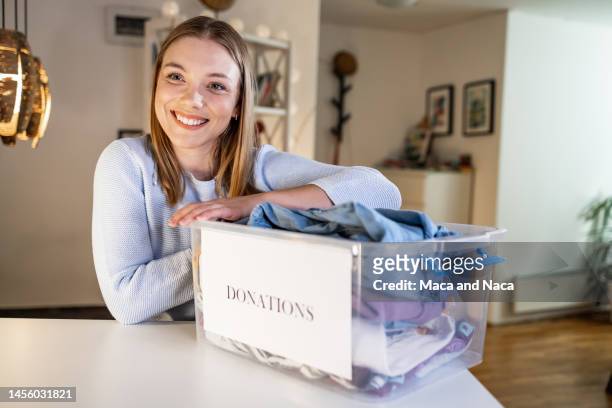 portrait of a young altruistic woman at home - medical symbol stock pictures, royalty-free photos & images