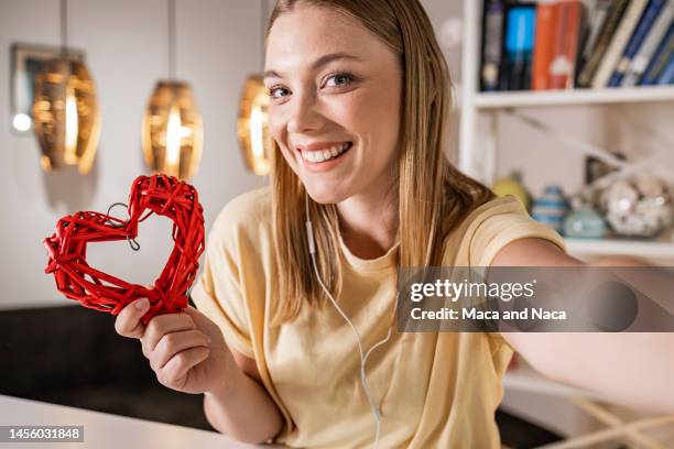 young woman celebrating valentine's day - valentine's day home stock pictures, royalty-free photos & images