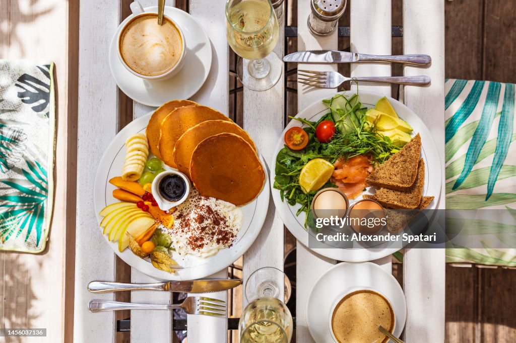 Luxury brunch with champagne served in a restaurant, directly above table top view